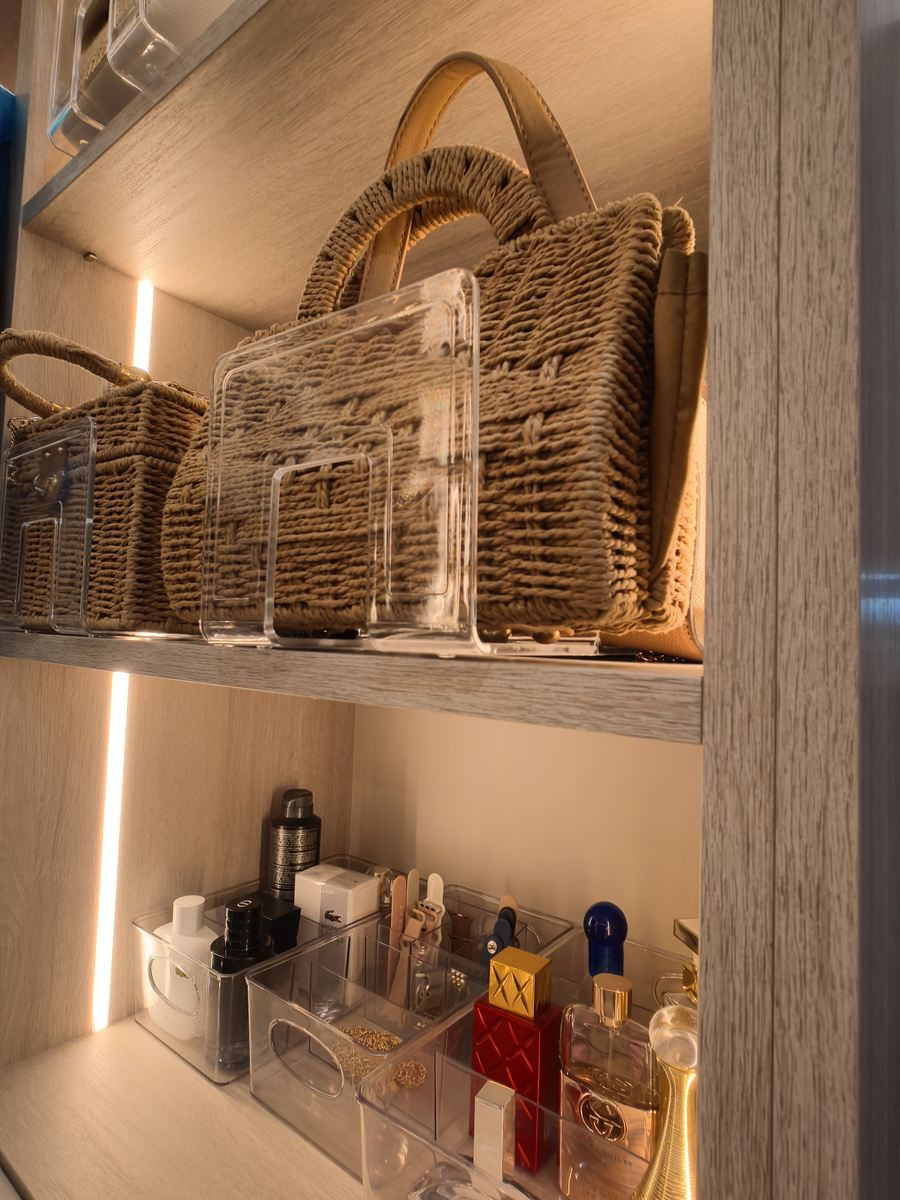LED-lit handbag and accessory display shelves in a custom walk-in closet