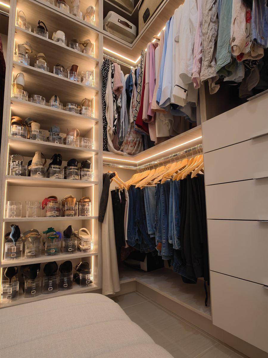 Tall lit shoe tower beside a drawer stack and long hanging section in a custom Miami closet
